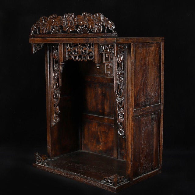 A beautifully crafted Chinese tabletop shrine cabinet, likely made of Huali (rosewood). The piece features a tall,...
