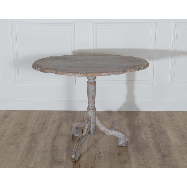 An authentic 18th-century Swedish Rococo tilt-top table, notable for its sculptural form and original construction. The...