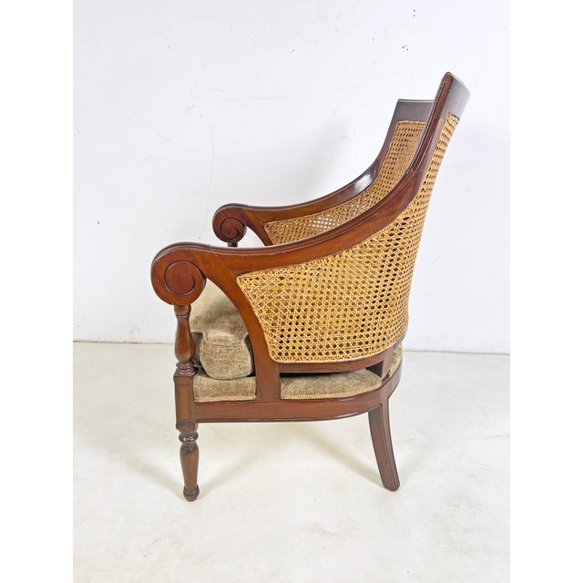 A classic English regency Anglo-Indonesian style library bergere in carved mahogany with double hand-caned back and sides...