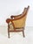 A classic English regency Anglo-Indonesian style library bergere in carved mahogany with double hand-caned back and sides...