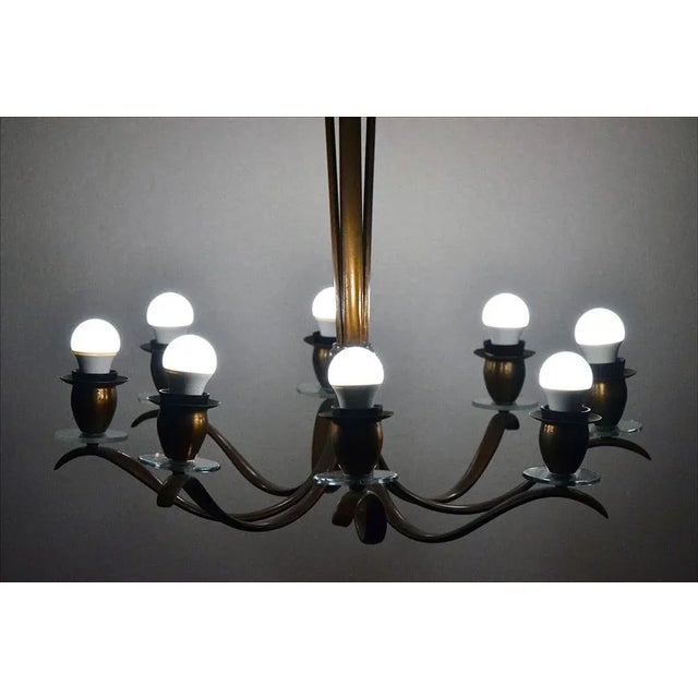 8-light brass chandelier Italian production early 1950s. Entirely hand-washed brass with curved arms and stem. Brass lamp...