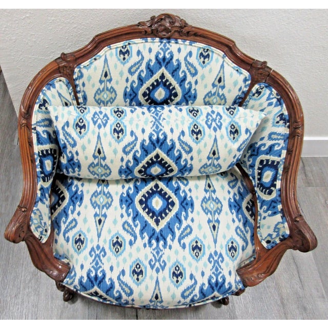 This Antique French Louis XV Carved Walnut French Bergère Armchair from the 18th century is a stunning piece of vintage...