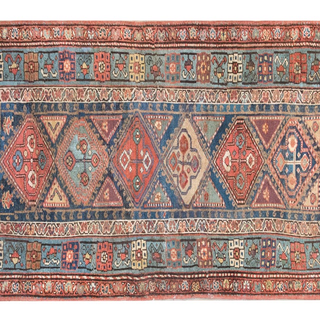 A striking early 20th-century Persian Azari rug, this piece is a testament to the rich weaving traditions of Azerbaijan....