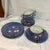 This is a set of vintage Japanese blue lusterware porcelain plates and tea cups featuring an iridescent finish and white...