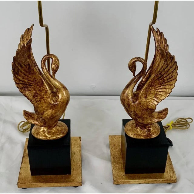 Elevate your interior with this striking pair of swan-form table lamps, crafted in porcelain and finished with a rich gold...
