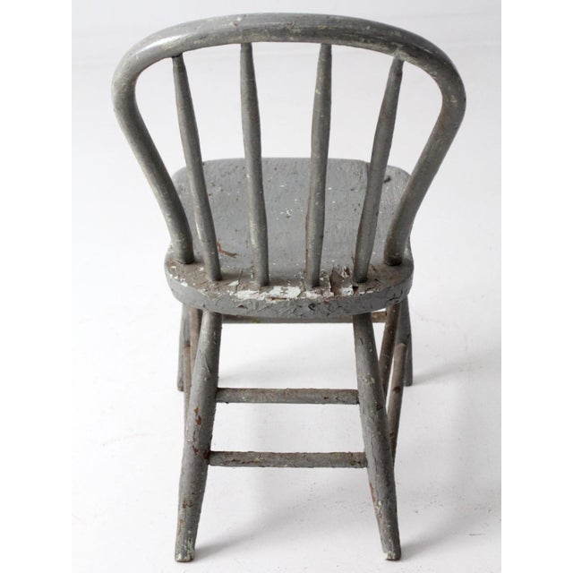 Antique primitive Windsor chair with a classic spindle back silhouette and softly worn presence. The original slate blue...