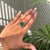 This striking 9.08-carat emerald-cut emerald solitaire ring is crafted in 18K yellow gold. The emerald, measuring about 15...