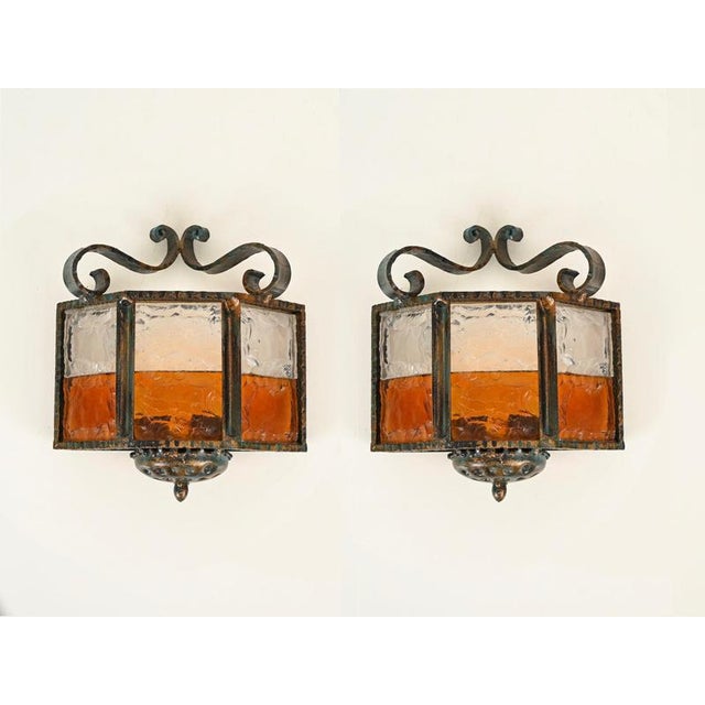 Wonderful and unique pair of brutalist sconces in wrought iron and sculpted glass. This gorgeous set was designed by...