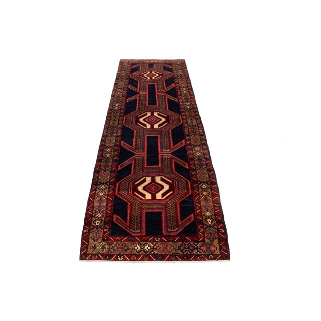 Vintage tribal Heriz In Navy Blue. This Runner has accents in red, brown, pink, and beige all over the motif. This rug...