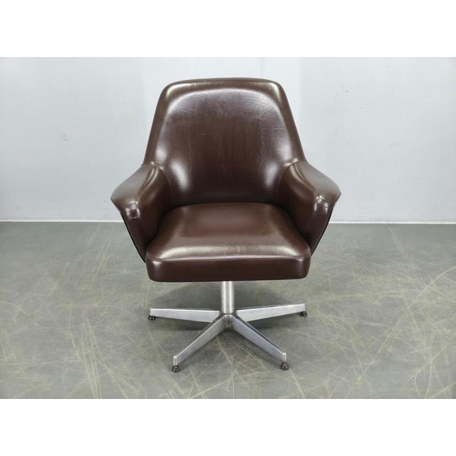 Elegant Mid Century Modern swivel lounge chair produced by Mobiltecnica Torino in Italy during the 1960s. This...