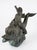Monumental bronze fountain depicting a classically rendered cherub (putto) riding a stylized dolphin, sourced from a Star...