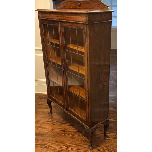 Early 20th-century Arts & Crafts bookcase in solid oak, retaining its original warm oak finish, antique patina, and...