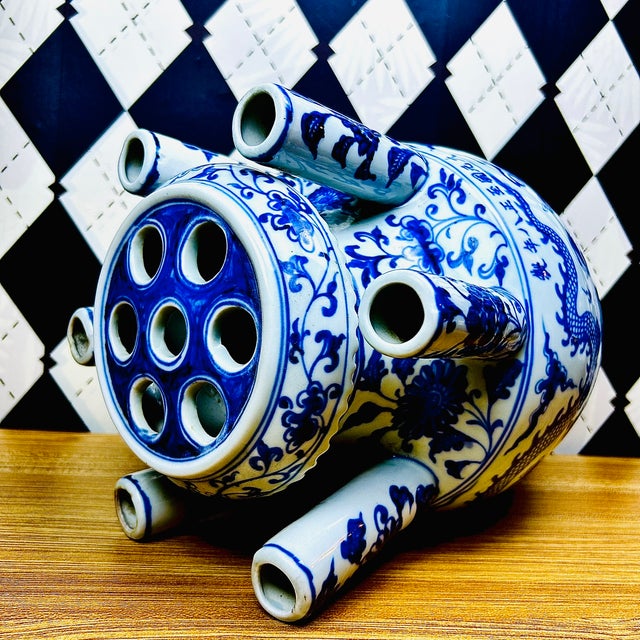Large blue and white porcelain tulipière featuring a dramatic multi-spout form and cobalt dragon decoration. Standing...