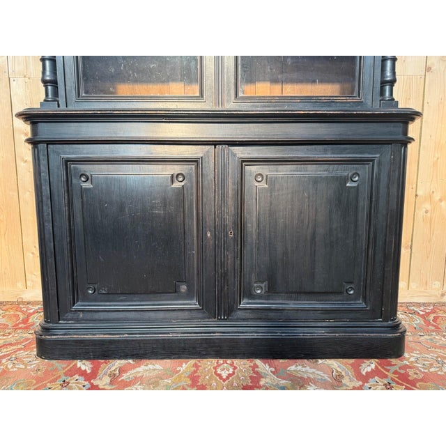 A two-part napoleon iii period buffet in ebonized wood, retaining its original antique glass. the upper section (h. 161...
