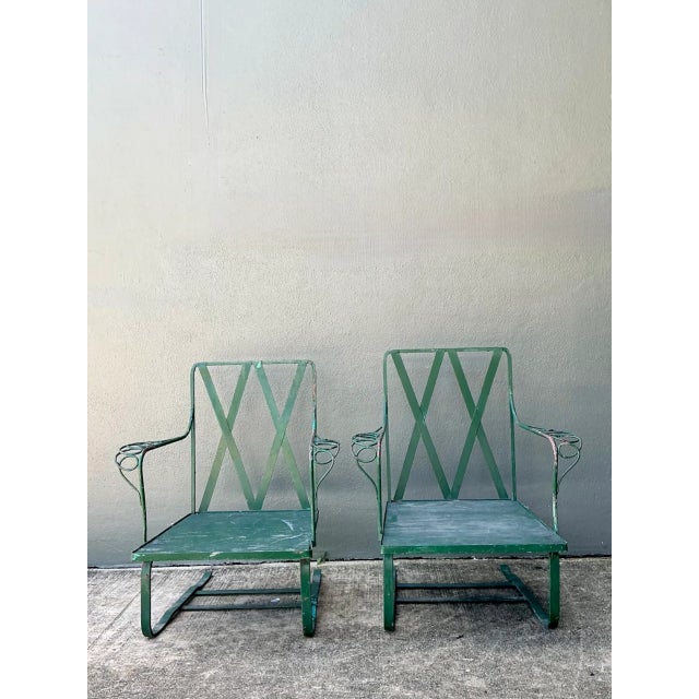 This pair of vintage sculptural iron Springer lounge chairs brings expressive mid-century design to a seating arrangement,...