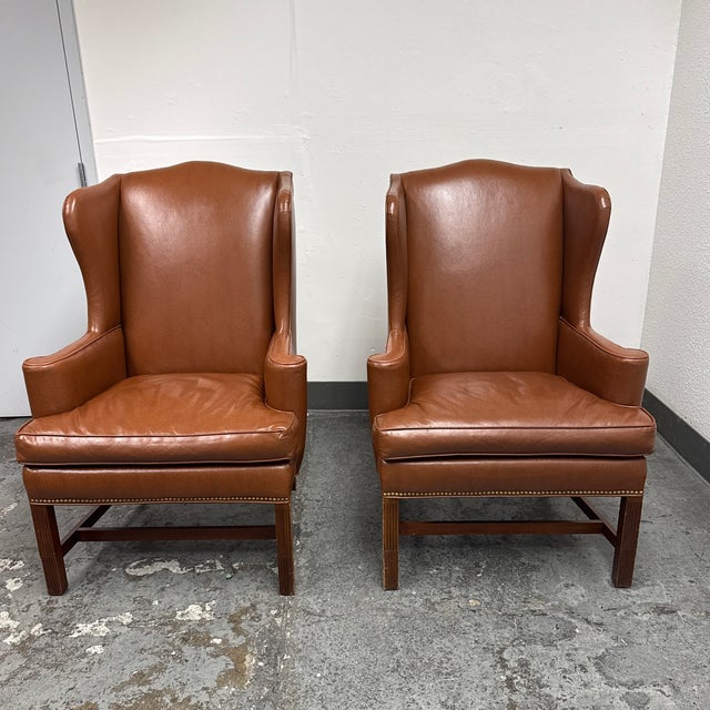 Design Plus Gallery presents a Pair of Bespoke Wingback Armchairs. These armchairs are upholstered in cognac ostrich-...