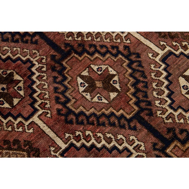 Beautiful Vintage Shiraz hand-knotted Wool rug with the brown field. This piece has a beige frame and multicolor accents...