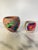 A charming pair of mid-century handmade pottery vessels from Tesuque, New Mexico, decorated in the brightly colored...
