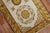 A late 19th century Khotan scatter rug. Field is ivory, gold and brown main accent colors. 1 end border has pops of...