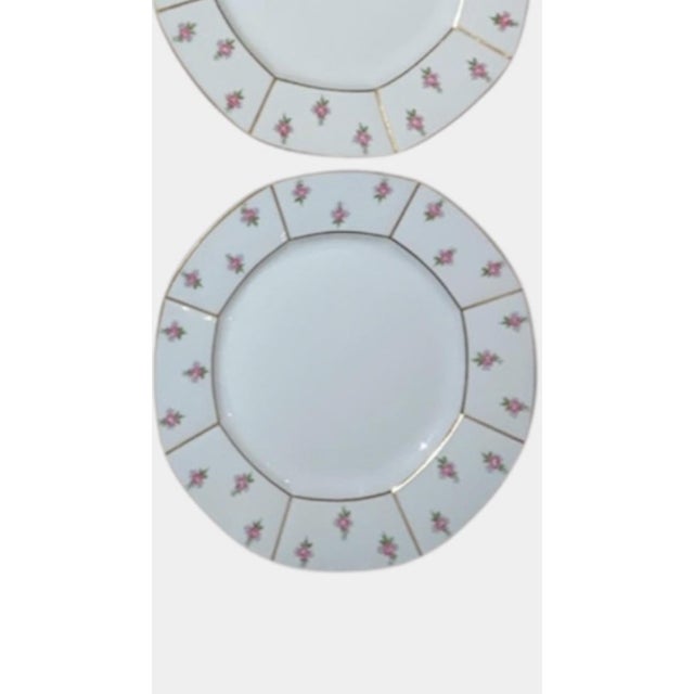 These 12 beautiful salad plates with pink rose buds on a white background trimmed in gold are all in excellent condition....