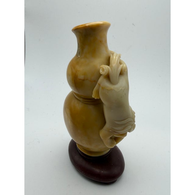 This soapstone carving is a double-gourd forn that symbolizes prosperity and good fortune. Double gourd is a popular art...