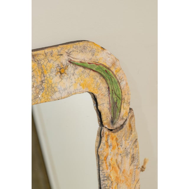 Vintage rectangular mirror with a glazed ceramic frame featuring a crackled finish. The frame, made of six handcrafted...