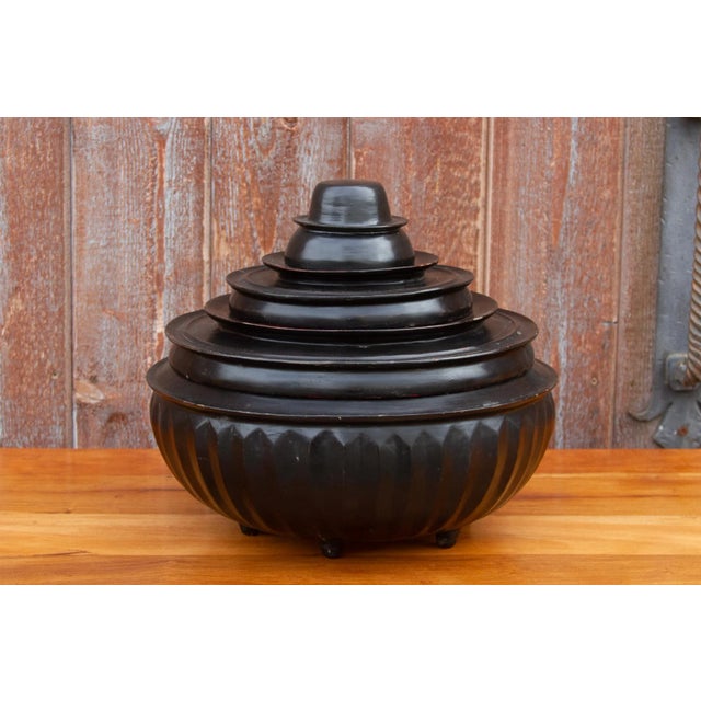 A late 19th century tiered black lacquered Monk offering bowl set. This offering set is made from bamboo in a black and...