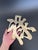A vintage brass trivet in the form of the Chinese prosperity symbol. It is fitted with a hanging ring for wall display as...