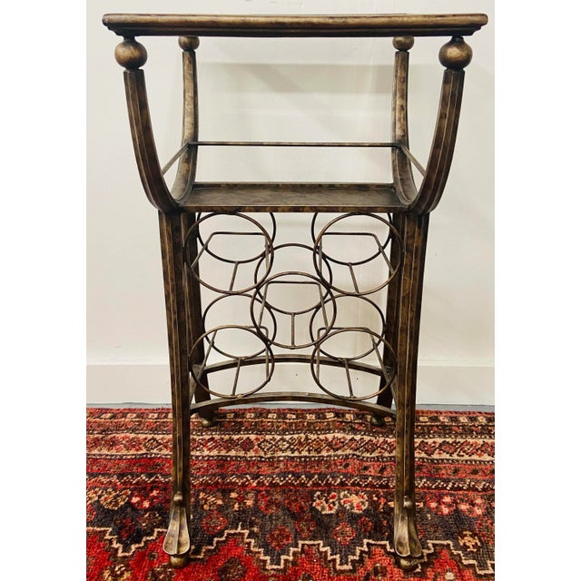 An exquisite vintage wine rack metal table in Vintaged finish. The table has a beveled top glass and can store up to 8...