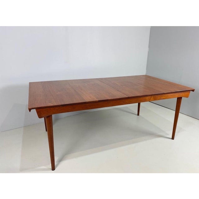 This extendable table designed by Finn Juhl is made of solid teak and combines elegant lines with practical functionality....