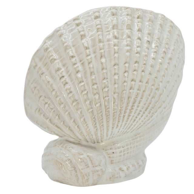 Sculpted in the likeness of a sea shell, it carries the quiet grace of ocean-tide memory. Its textured relief, washed in...