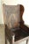 A finely carved 18th-Century English Georgian Manor chair with plank seat. It has a heavily carved back panel with...