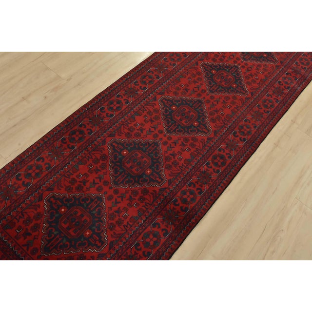An authentic tribal Turkmen rug hand-knotted with fine wool and natural dyes. This nomadic rug features a row of geometric...