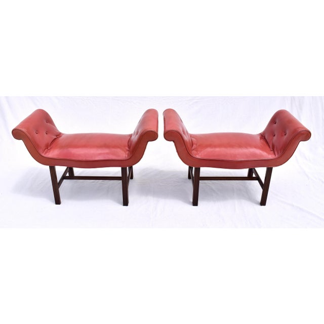 An exceptional pair of English leather saddle form Mahogany Chippendale window benches with flanking scrolled arms and H...