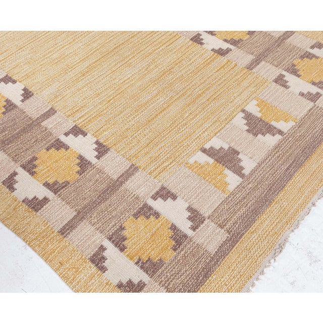 Radiating warmth and Scandinavian elegance, this vintage Swedish flat woven rug, signed with the initials "JR," is a...