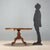 English-made walnut sail table from the late 19th century. The elliptical top is enhanced with stringing and a central...