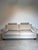 Elegant contemporary three-seater sofa upholstered in a soft neutral beige fabric, combining clean lines with generous...