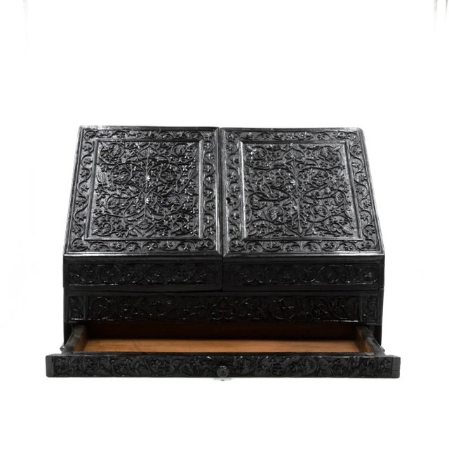 An impressive and intricately carved solid ebony stationery box with fully fitted satinwood interior; Anglo-Indian, circa...