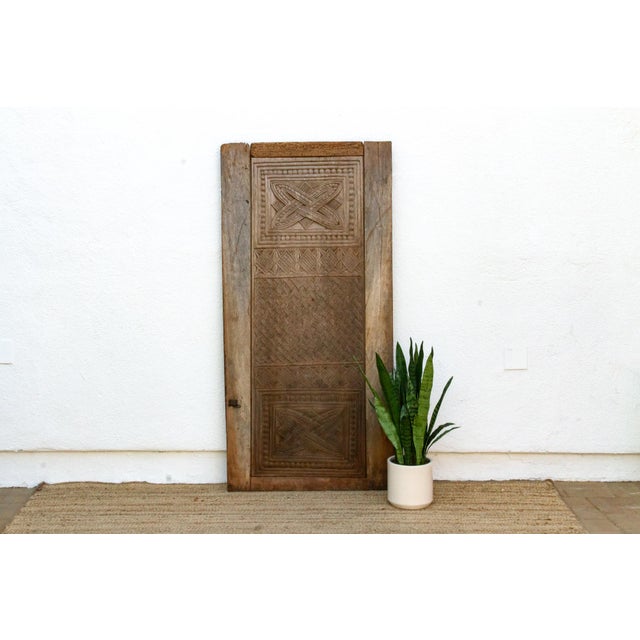 Some motifs you recognize the instant you see them. The bold X carved into a diamond frame at the heart of this panel is...