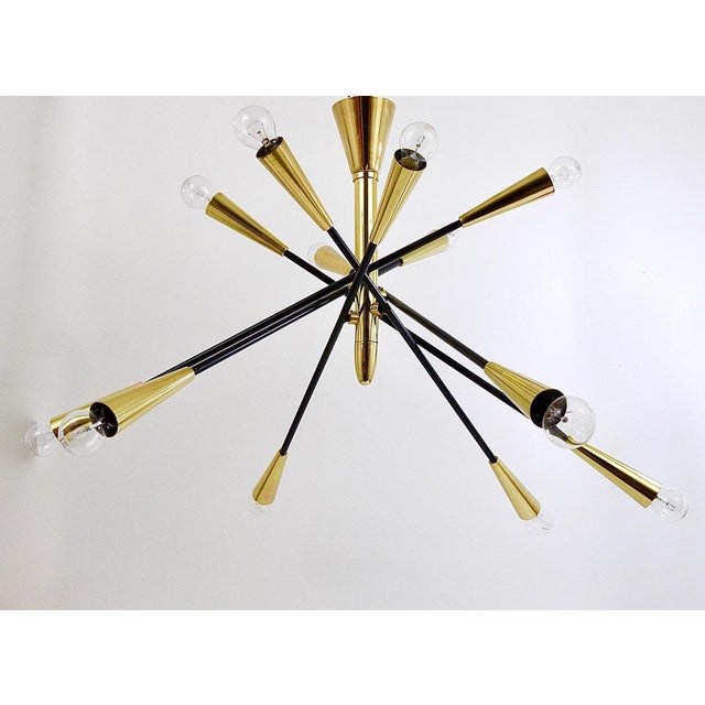 A large and impressive Italian midcentury Sputnik chandelier with articulating / adjustable arms from the 1950s. In the...