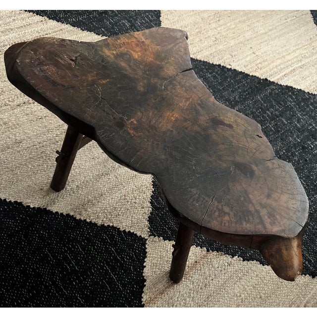 1940s live edge solid wood coffee table with natural grain. All-wood base with pegged construction. Age-appropriate checking.