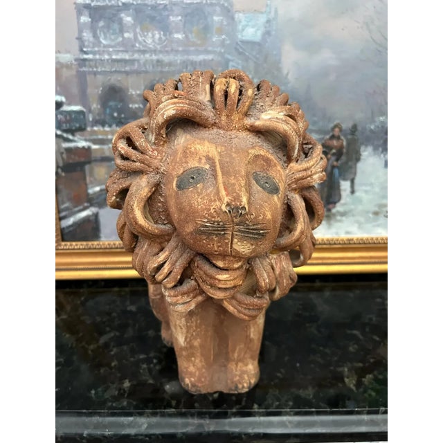 A sculptural Italian ceramic lion attributed to Aldo Londi for Bitossi, featuring the designer’s signature stylized form...