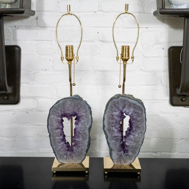 Pair of brass table lamps composed of large amethyst geode fragments.