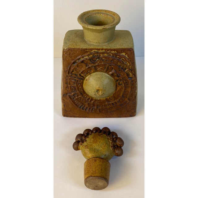 A striking sculptural studio pottery earthenware vessel featuring a richly textured, architectural form and an...
