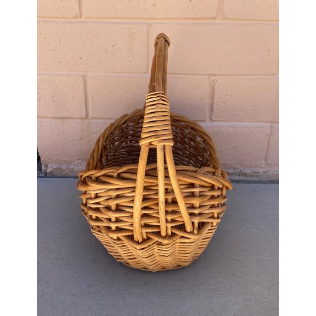 Woven Rattan Gathering Basket, large in size with braided edge detail. Perfect for decoration with faux flowers or your...