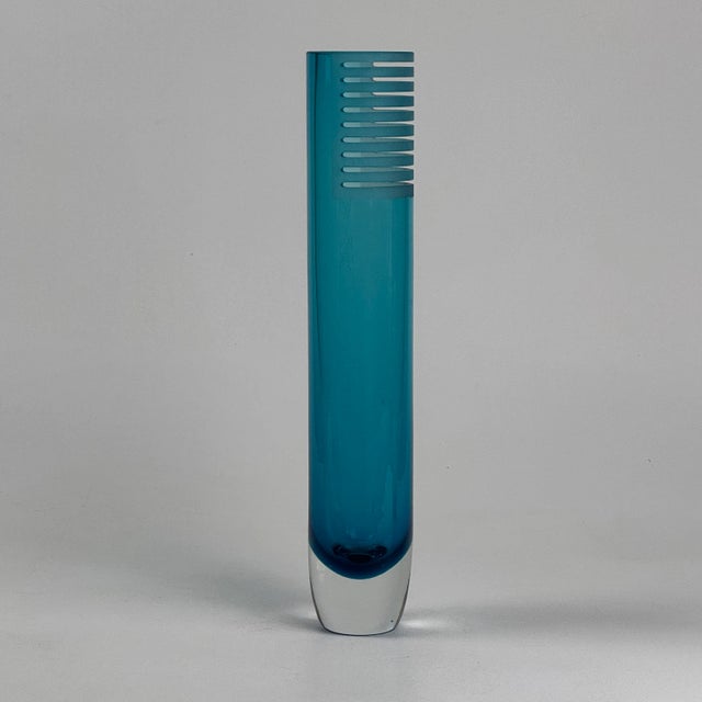A gorgeous vintage tall art glass vase in aqua blue color with a post modern design. The glass is cut in a layering effect...