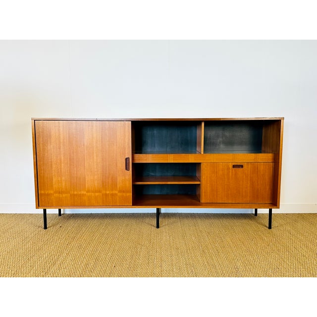 Vintage Scandinavian teak sideboard dating from the 1960s. Features a sliding door, a hinged door, and ample storage....