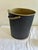 Vintage Mid-Century wastebasket featuring a textured matte black exterior with brass-tone interior and matching metal...