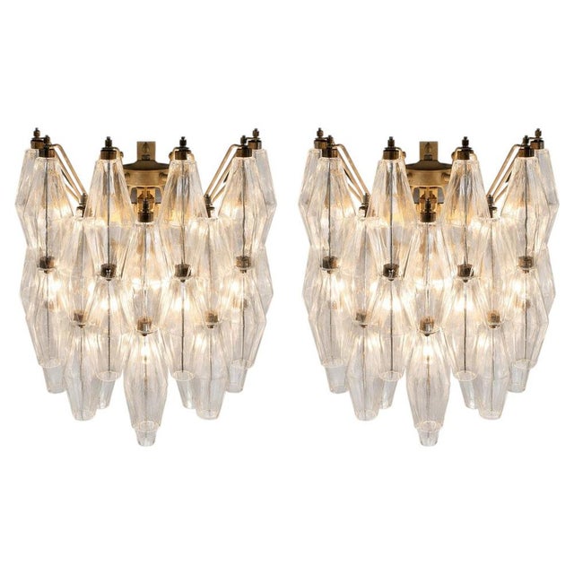 Pair Italian vintage pair of wall sconces in Murano glass and nickel-plated metal structure. The armor polished nickel...