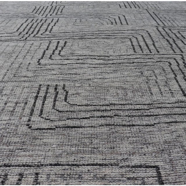 Keivan Woven Arts Hand Knotted Rug in Modern Design and fine wool Measures 6'0 x 8'8 This modern area rug features varying...